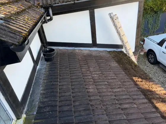 Clean tiled roof below a Tudor-style dormer