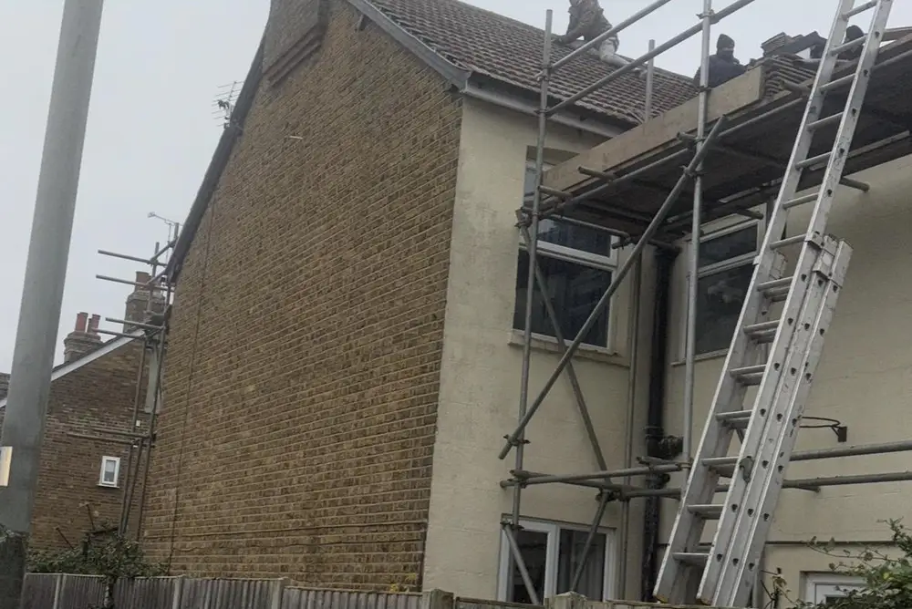 Scaffolding and ladders up on a house ready for roof work