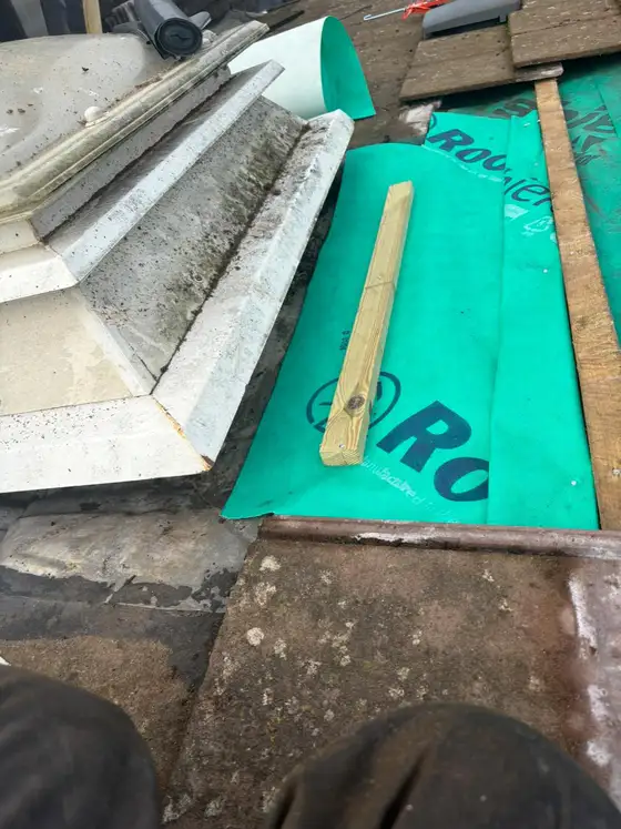 New membrane and lead flashing being fitted around a roof window