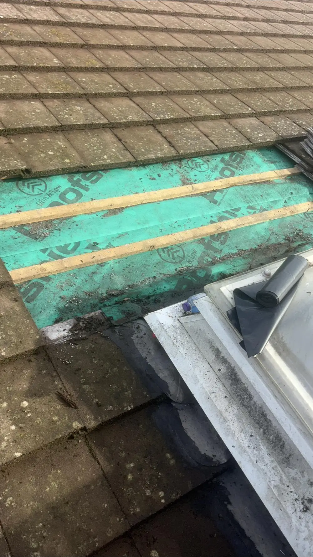 Tiles lifted to show new membrane and battens in a valley repair
