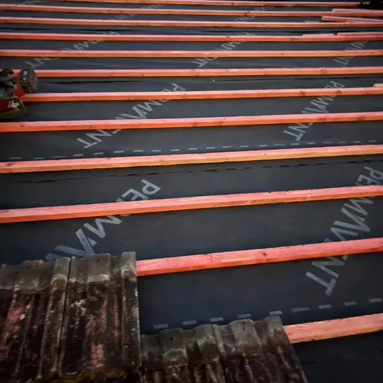 Rows of new treated battens laid over roofing membrane