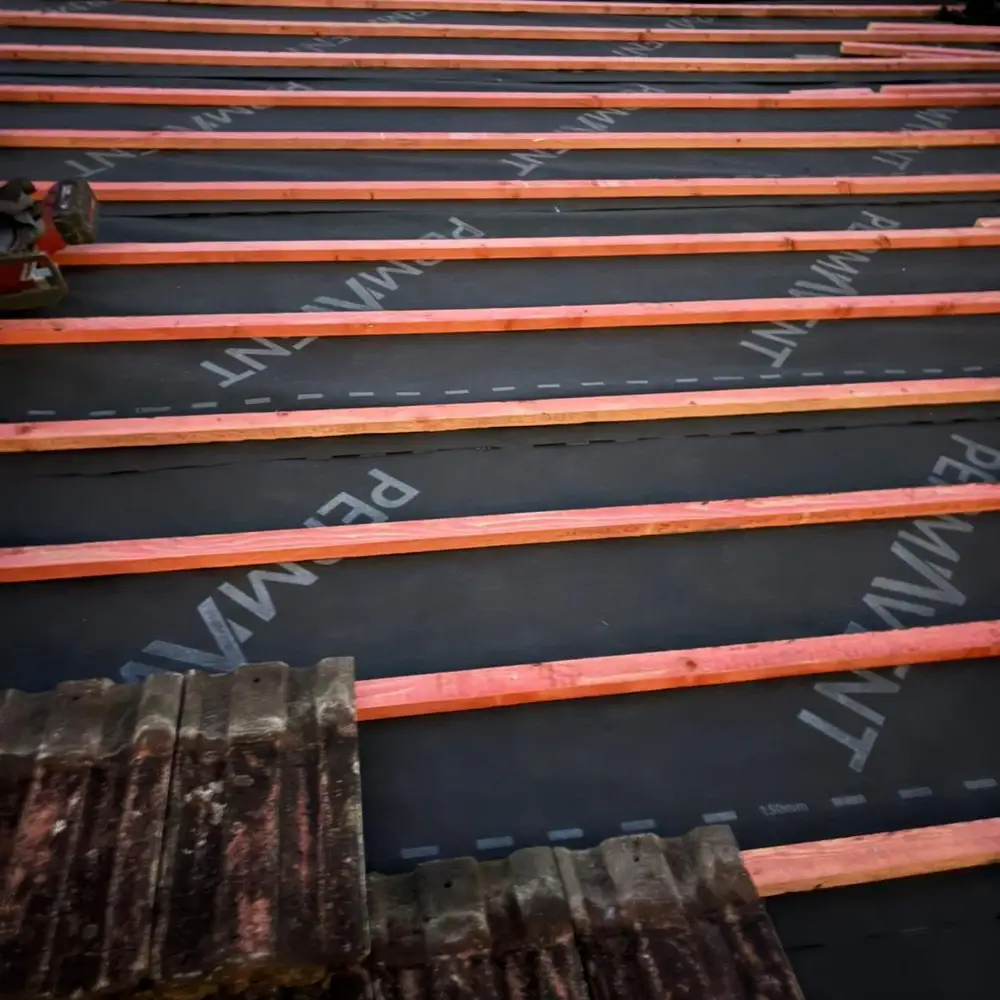 Rows of new treated battens laid over roofing membrane