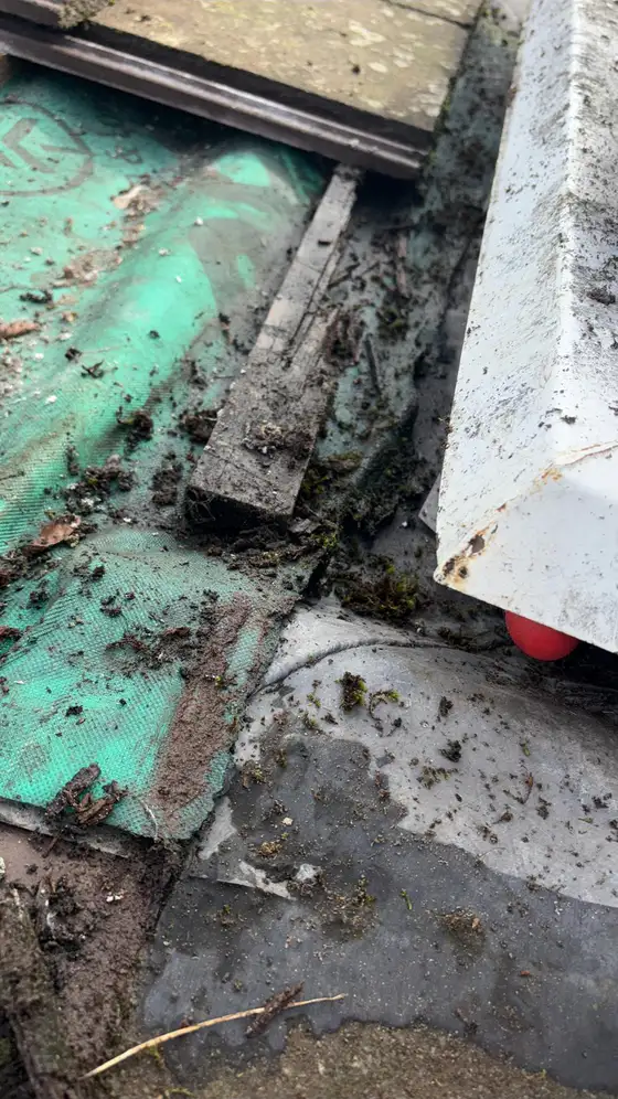 Old felt and lead exposed during a roof repair