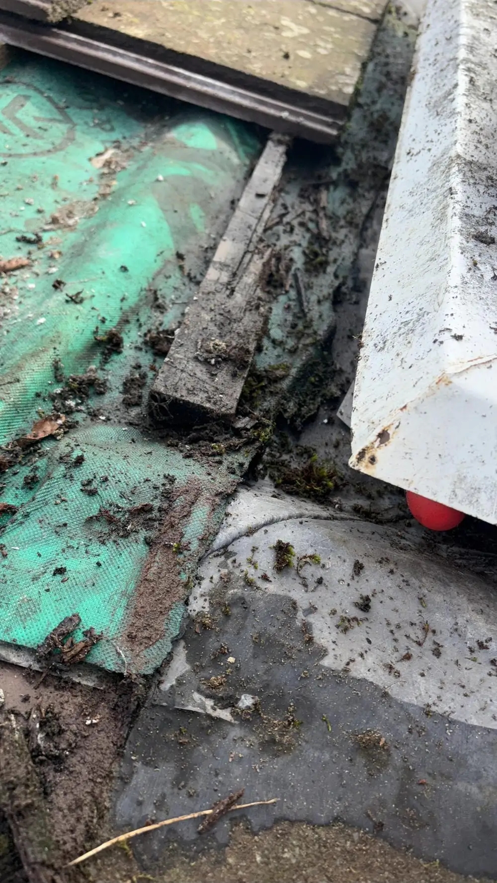 Old felt and lead exposed during a roof repair
