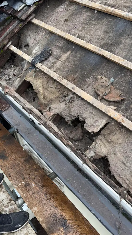 Perished felt and old battens along the eaves of an old roof