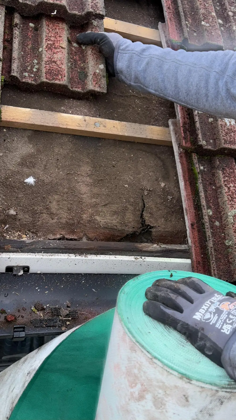 Old tiles being stripped back by hand to reach the battens